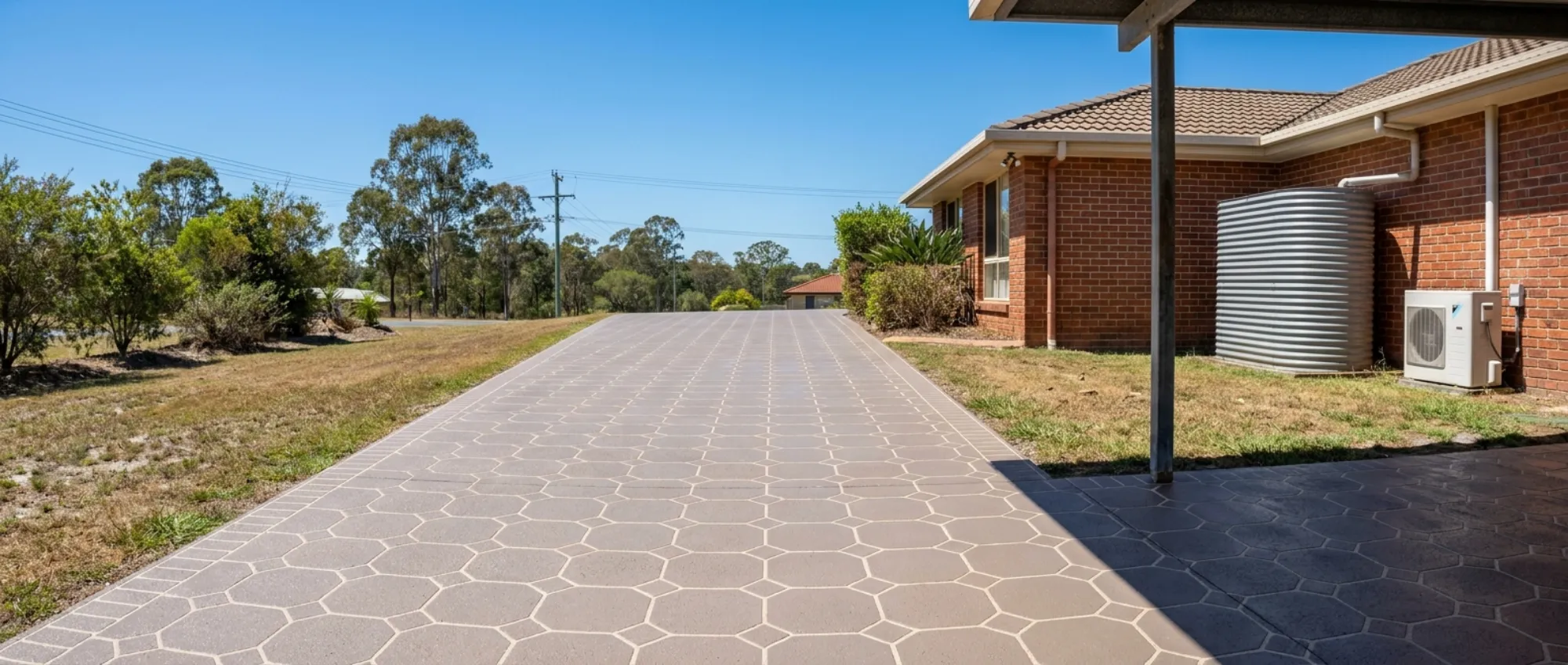 Sloping Logan driveway resurfaced in a mushroom grey-brown overlay with an octagon-and-square tile pattern