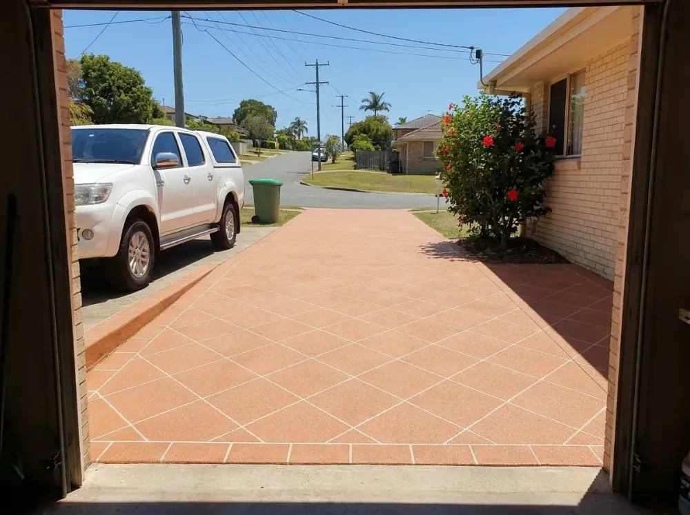 Terracotta decorative concrete driveway in a 45-degree diamond tile grid with white grout lines