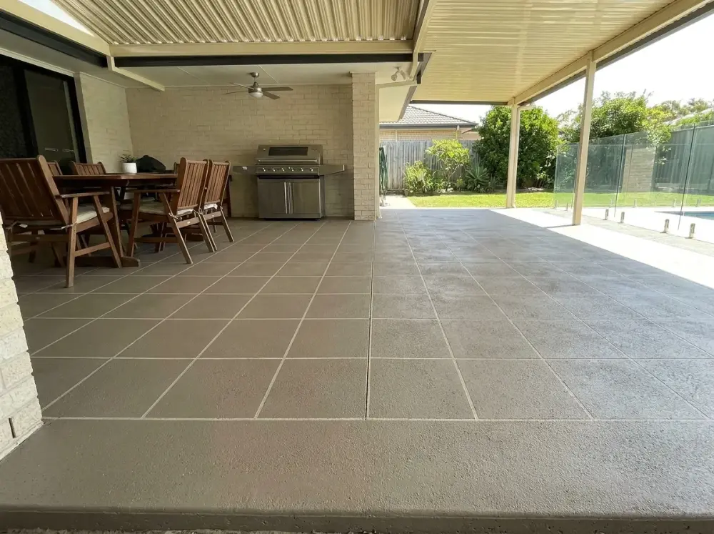 Covered alfresco entertaining area resurfaced in a mushroom grey-brown square tile pattern