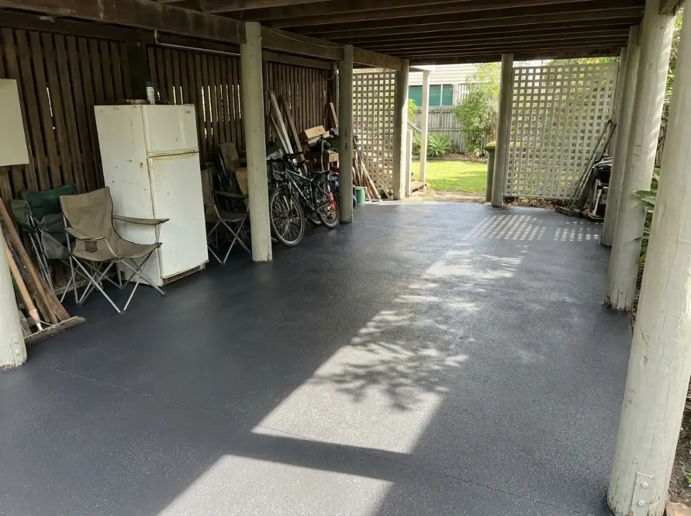 Under-house area of a Queenslander resurfaced in charcoal seamless slate-look concrete