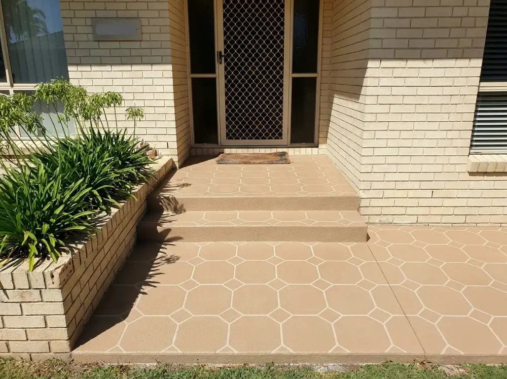 Tan octagon-and-square tile pattern decorative concrete front entry path and steps