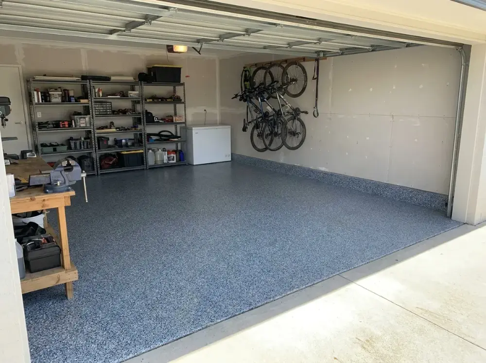 Domestic double garage floor finished in blue-grey epoxy flake coating with a satin clear coat