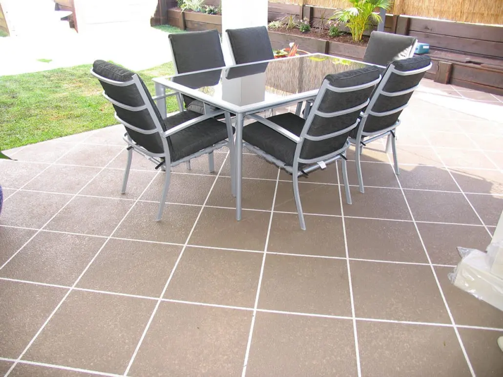 Covered patio resurfaced with a tile-pattern decorative concrete overlay