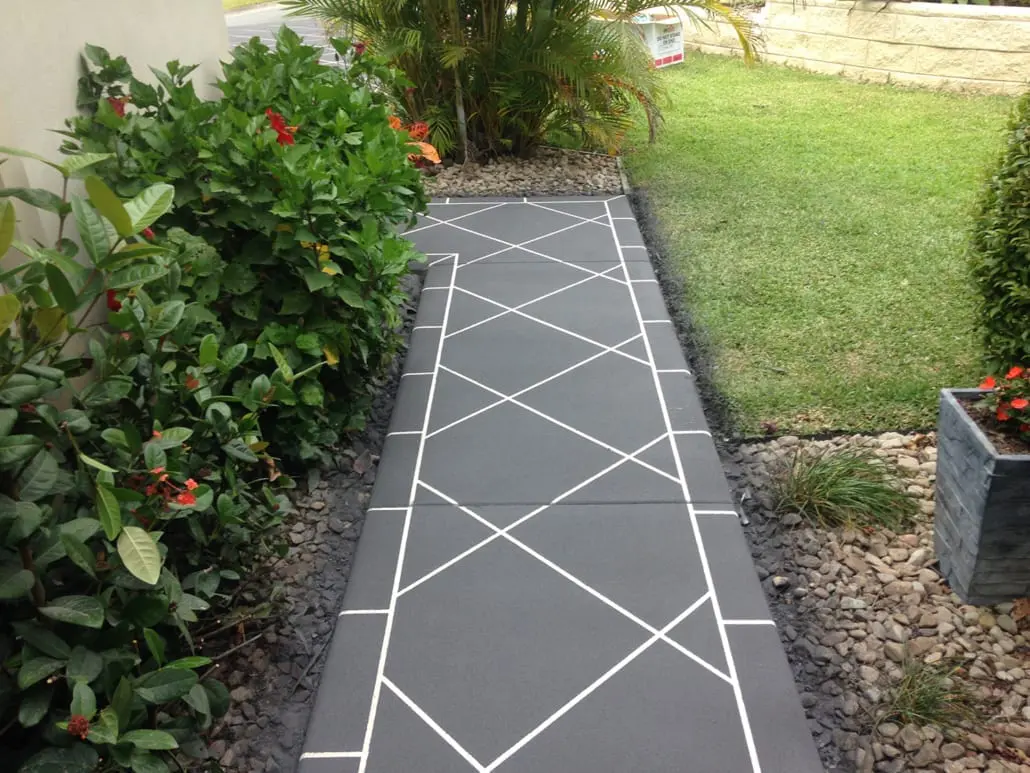 Seamless decorative concrete footpath sealed to a low satin sheen beside a garden bed